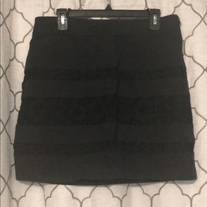 Brand new, short black skirt with lace design